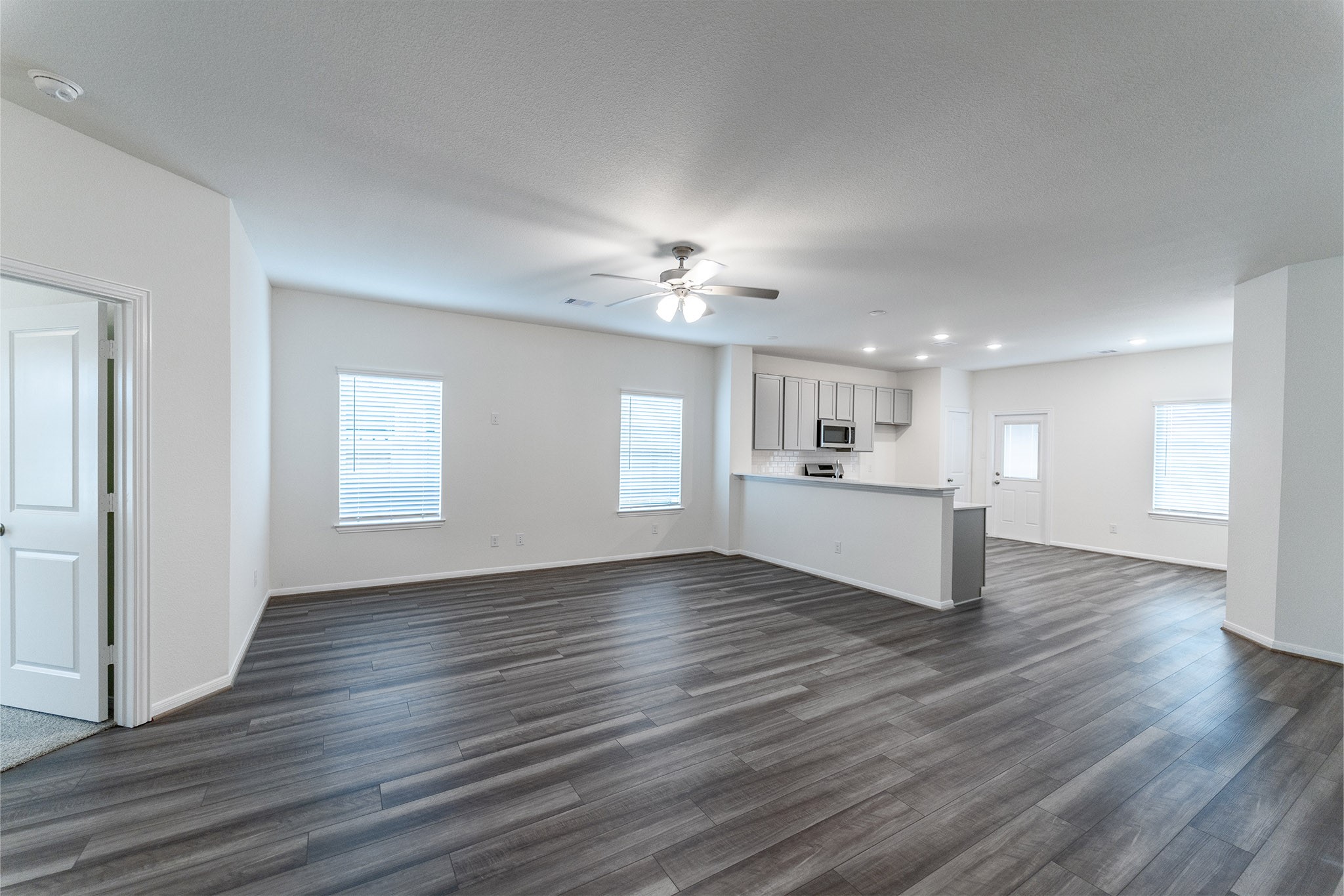 3527 Prairie Rose Trail Angleton, TX 77515 - Photo 4 of 19 wooden floor in an empty room with a window
