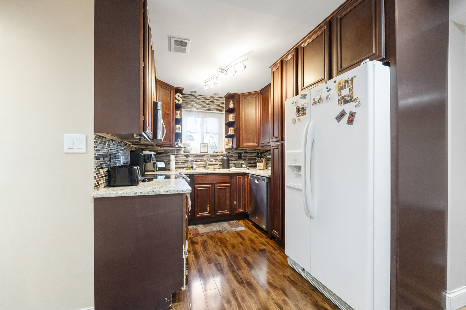 9645 South Harlem Avenue, Unit 1H Chicago Ridge, IL 60415 - Photo 7 of 14 a kitchen with stainless steel appliances granite countertop a refrigerator and a stove