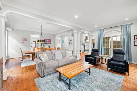 a living room with furniture and a wooden floor