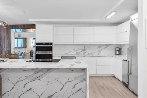 a kitchen with stainless steel appliances a stove a sink and a refrigerator