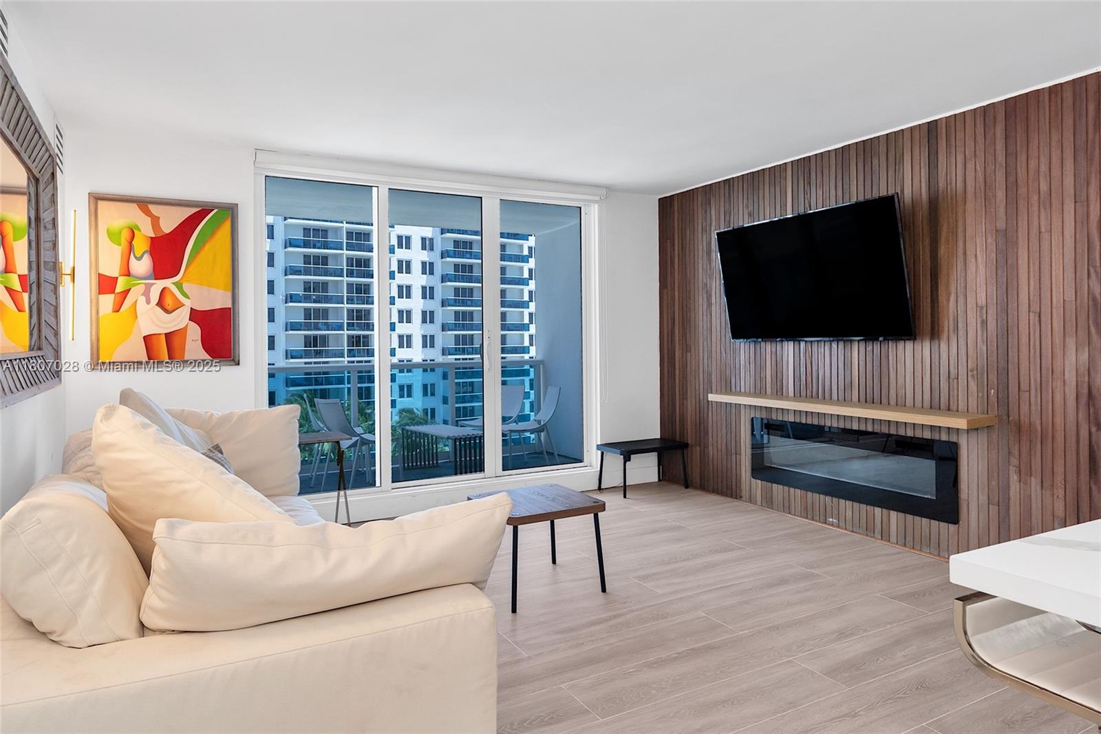 2301 Collins Avenue, Unit 1019 Miami Beach, FL 33139 - Photo 15 of 35 a living room with furniture and a flat screen tv