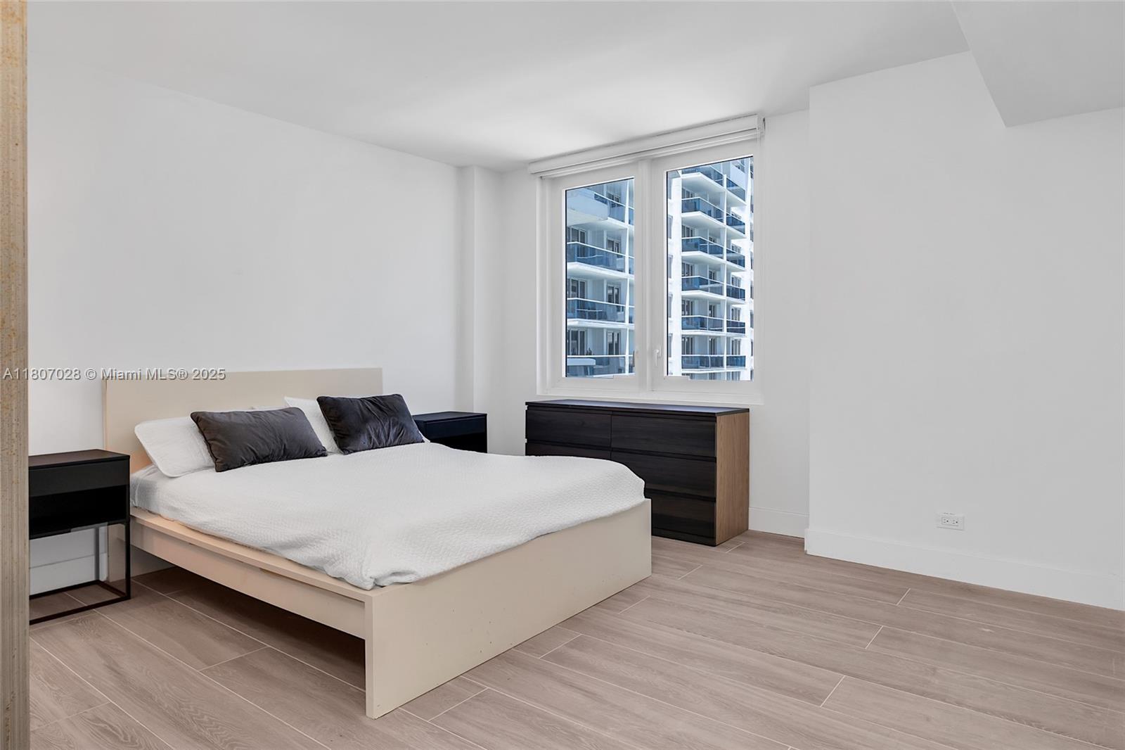 2301 Collins Avenue, Unit 1019 Miami Beach, FL 33139 - Photo 24 of 35 a bedroom with a bed and a window
