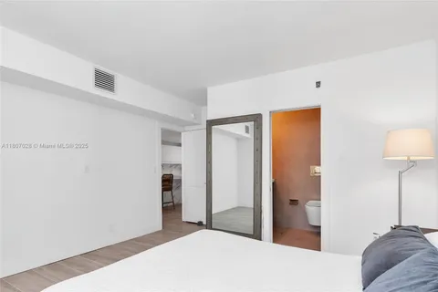 a bedroom with a bed and a lamp