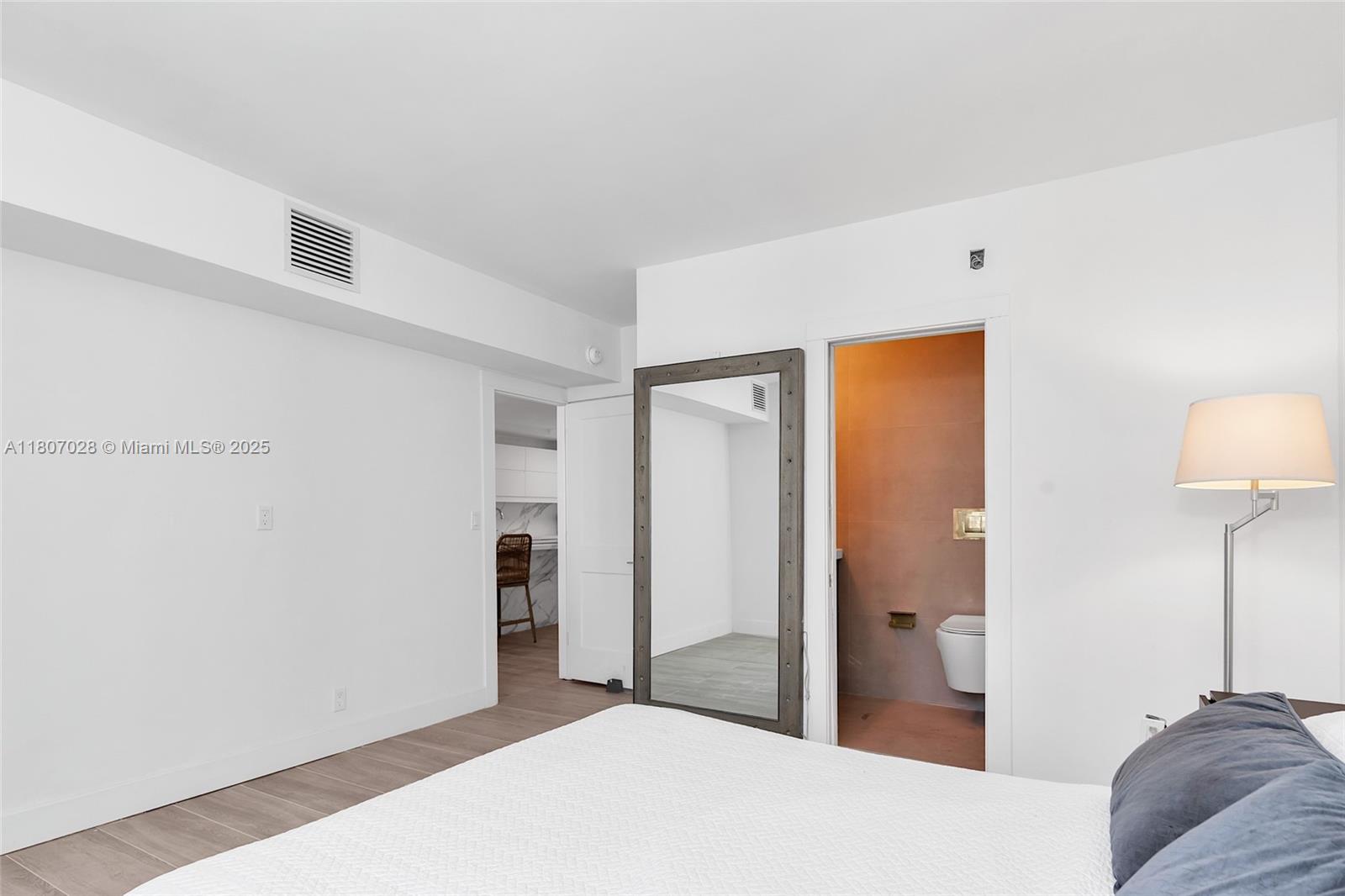 2301 Collins Avenue, Unit 1019 Miami Beach, FL 33139 - Photo 26 of 35 a bedroom with a bed and a lamp