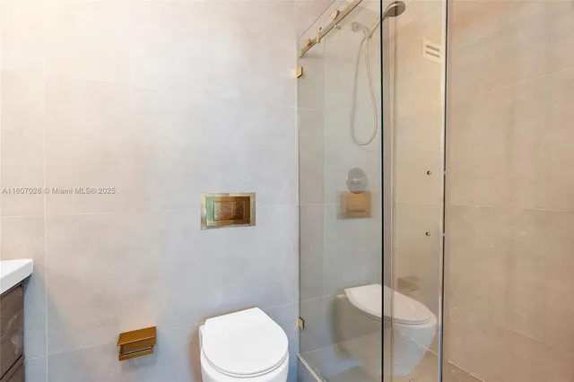 a bathroom with a toilet and a shower