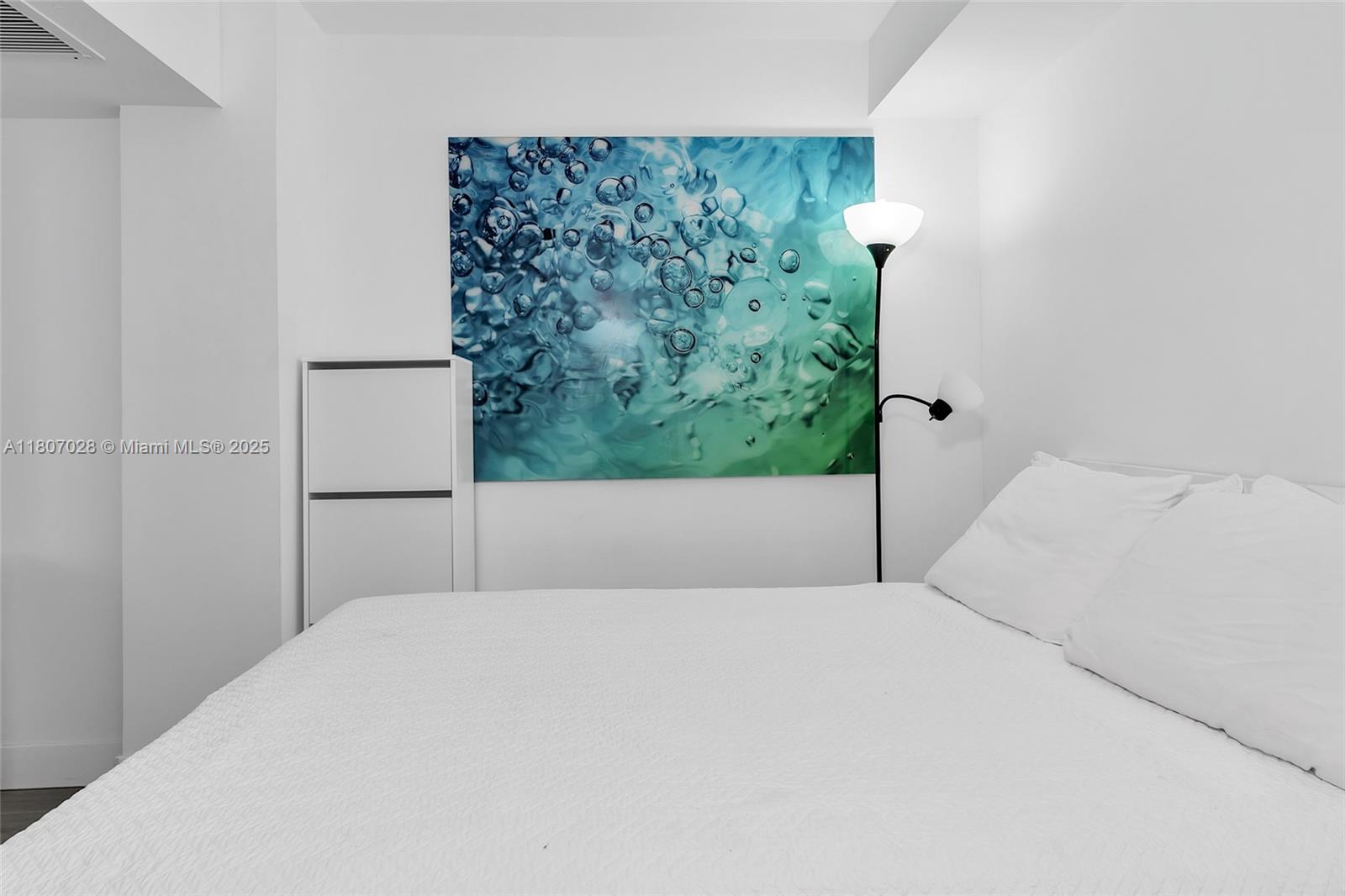 2301 Collins Avenue, Unit 1019 Miami Beach, FL 33139 - Photo 30 of 35 a bedroom with a bed and a window