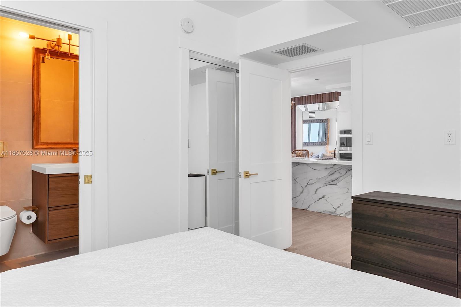 2301 Collins Avenue, Unit 1019 Miami Beach, FL 33139 - Photo 31 of 35 a bedroom with a bed and a dresser