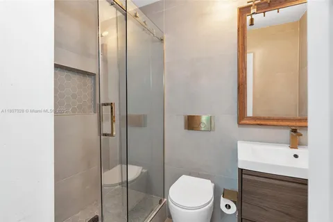 a bathroom with a toilet a sink and shower