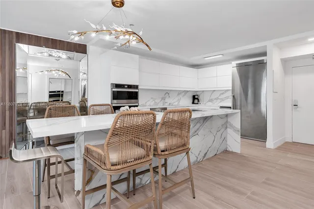 a living room with stainless steel appliances kitchen island granite countertop furniture and fireplace