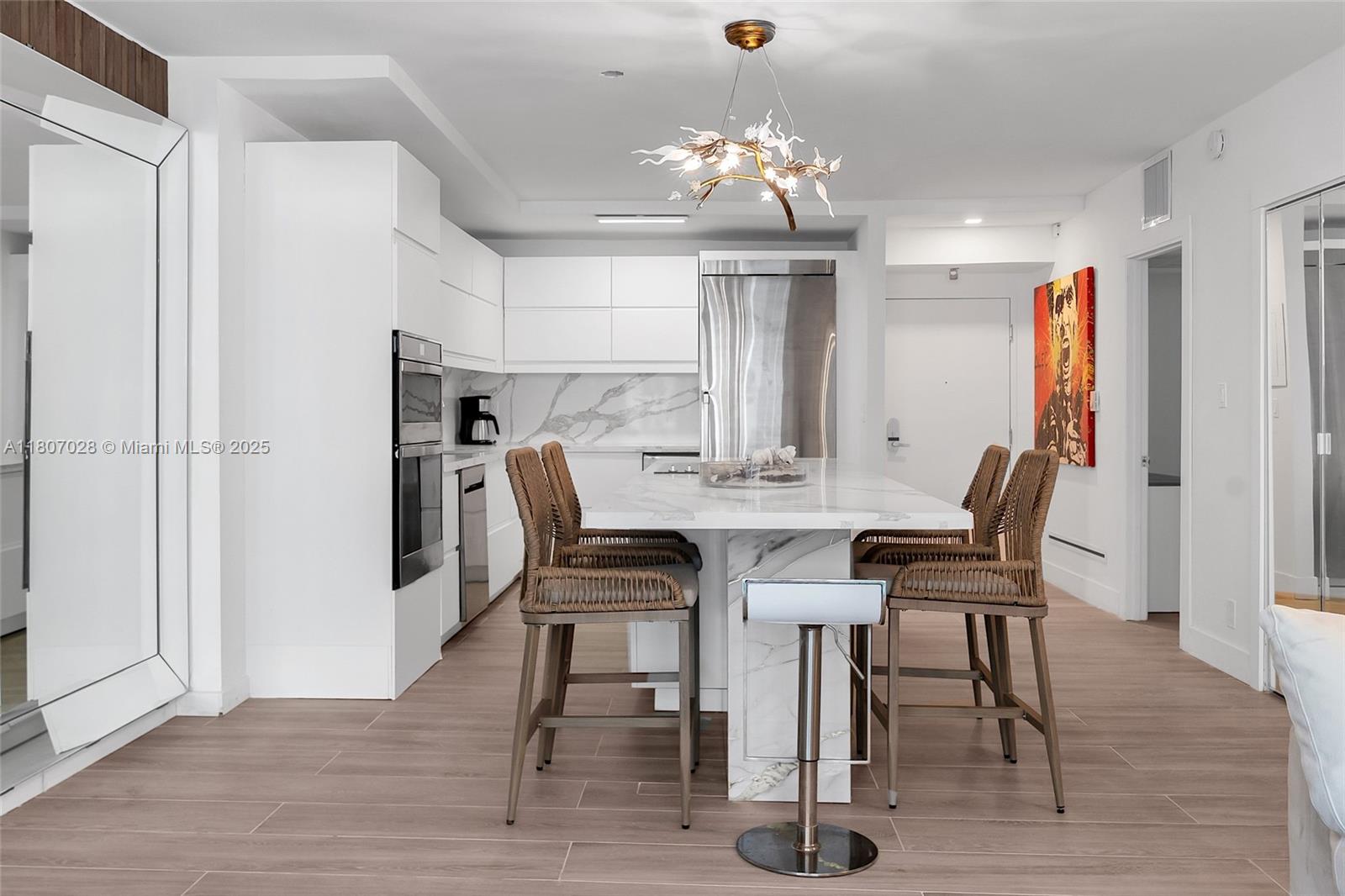 2301 Collins Avenue, Unit 1019 Miami Beach, FL 33139 - Photo 8 of 35 a view of a dining room with furniture and wooden floor