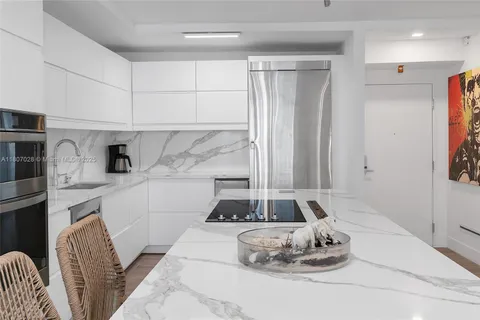 a kitchen with a refrigerator and a sink