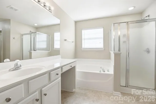 a bathroom with a tub sink and a mirror