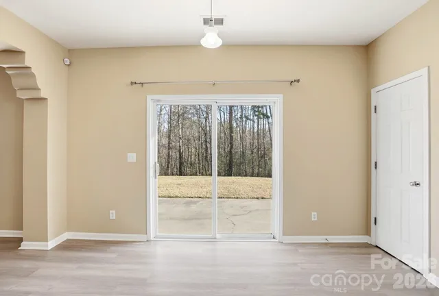 a view of a room with wooden floor and fan