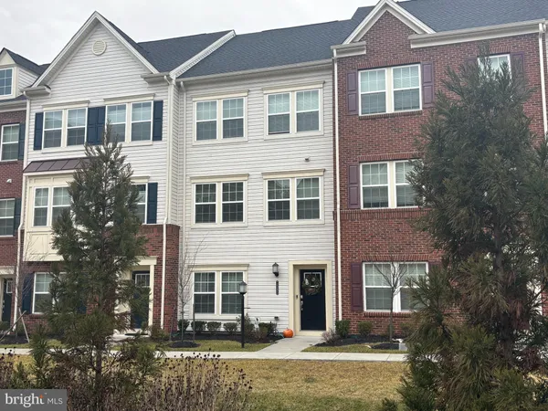 a front view of a house with yard and green space