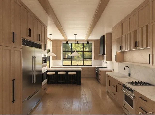 a kitchen with stainless steel appliances a stove a sink dishwasher a refrigerator and cabinets with wooden floor