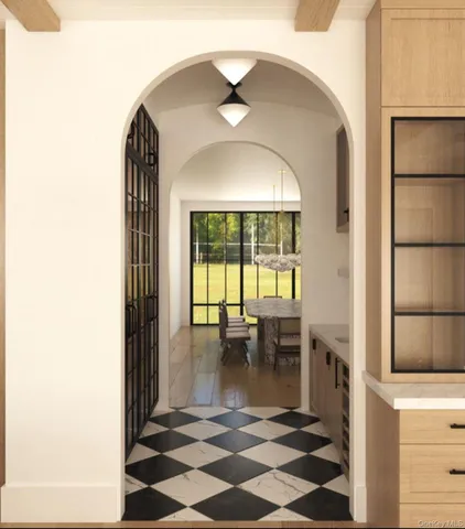 a view of a room that has a bed and a table in it