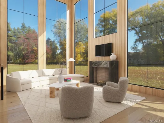 a living room with couches a coffee table and a flat screen tv