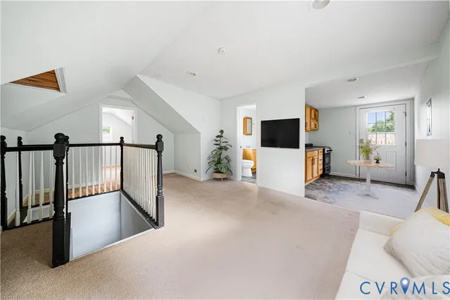 a view of a livingroom with furniture and stairs