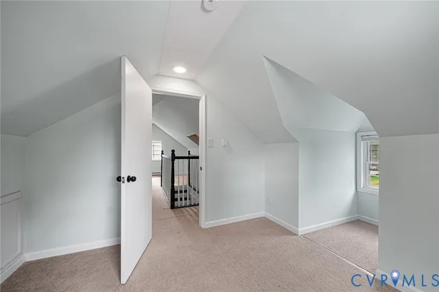 a view of a hallway with entryway and stairs