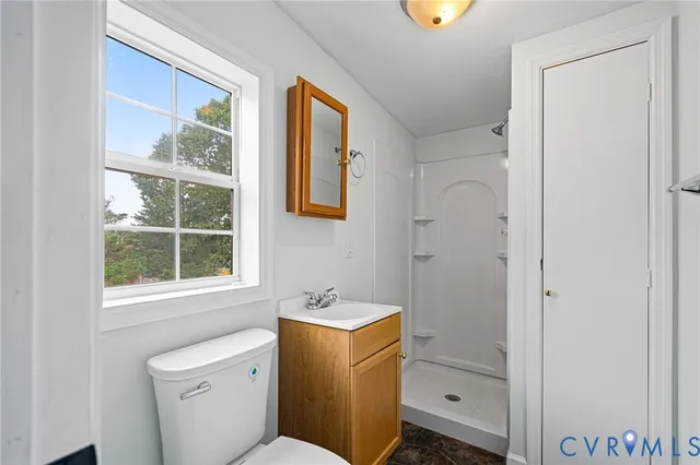 a bathroom with a sink toilet and window