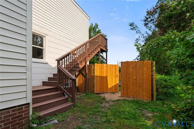 a view of backyard with stairs and wooden stairs