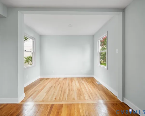 a view of a room with wooden floor and window