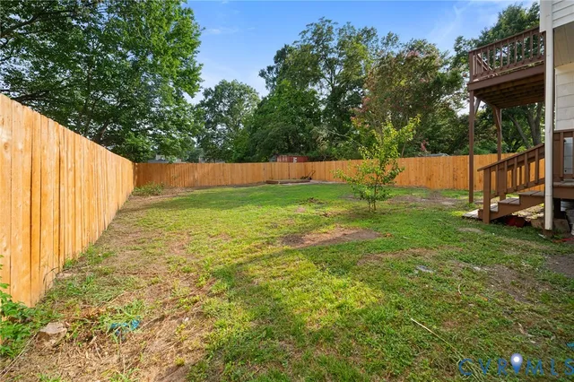a view of yard with swimming pool and trees in the background