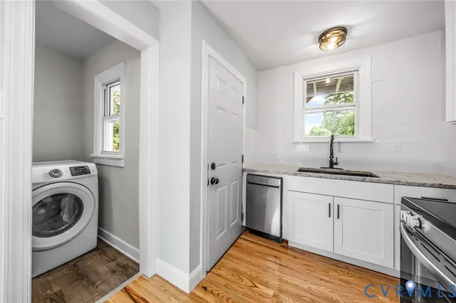a kitchen with stainless steel appliances granite countertop a sink and a window