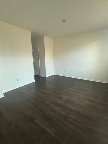 an empty room with wooden floor