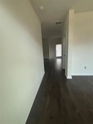 a kitchen with a sink cabinets and wooden floor