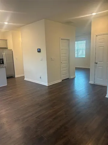 a view of a living room a kitchen with wooden floor