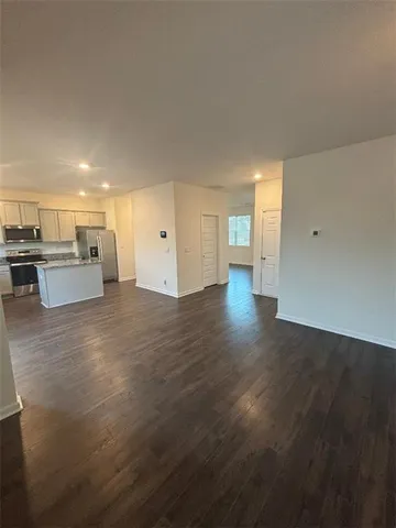 a view of a hallway to rooms