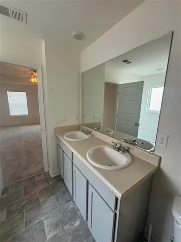 a bathroom with a glass door shower and a sink