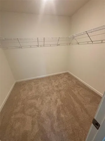 a view of an empty room with a ceiling fan