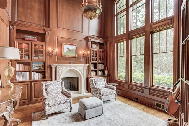 a living room with furniture and a floor to ceiling window