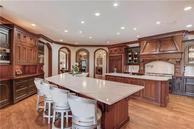 a bedroom with a large bed and a chandelier