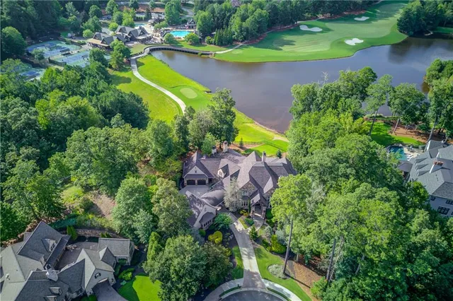 an aerial view of a house with a swimming pool yard and outdoor seating