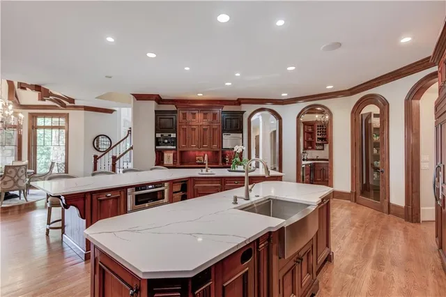 a bedroom with a bed a chair and a chandelier