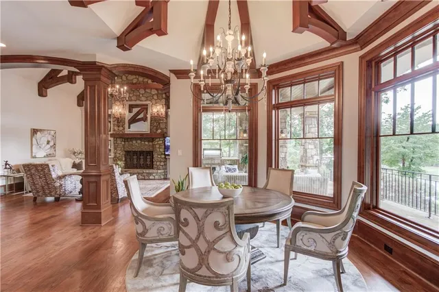 a view of entryway and dining room with wooden floor