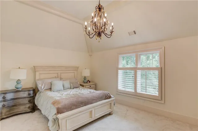 an aerial view of a house with a yard and large trees