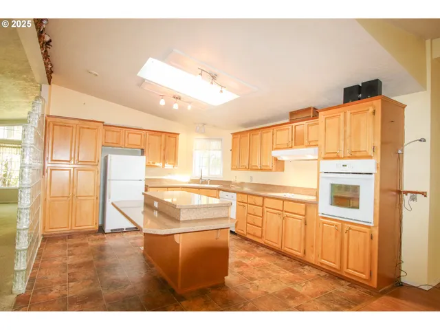 a kitchen with stainless steel appliances granite countertop a refrigerator and a stove