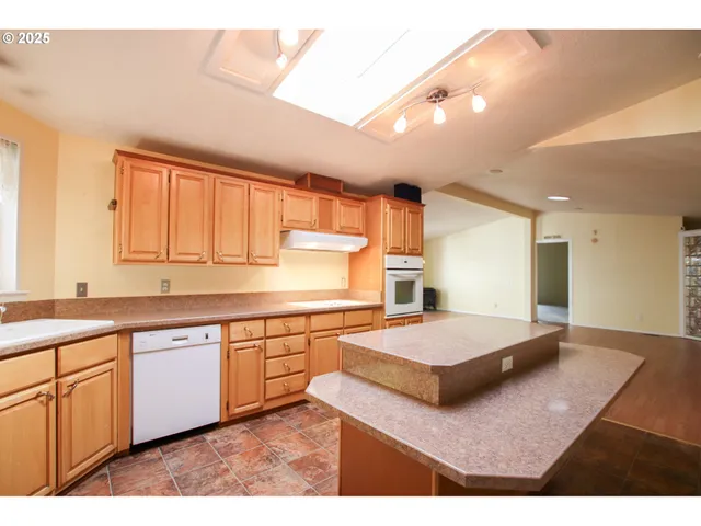 a spacious bathroom with a granite countertop sink a large mirror and a bathtub