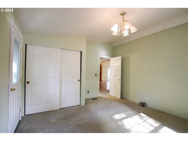 a view of an empty room with a chandelier