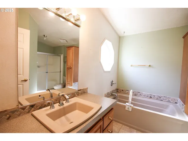 a bathroom with a sink mirror and vanity