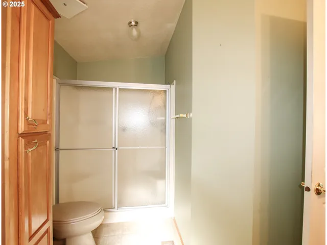 a bathroom with a toilet and a shower