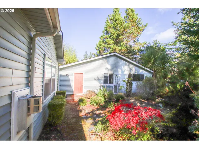 a backyard of a house with flower plants