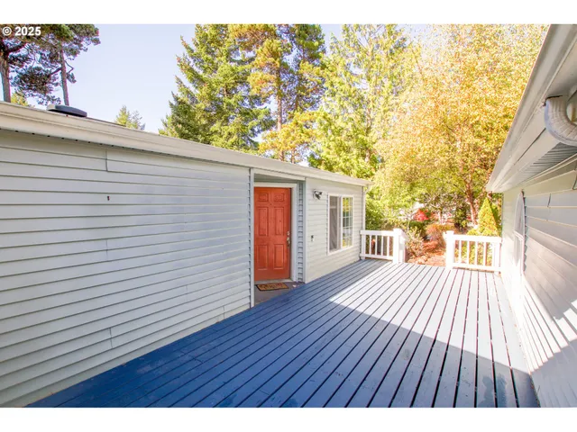 a view of backyard with a deck and wooden floor
