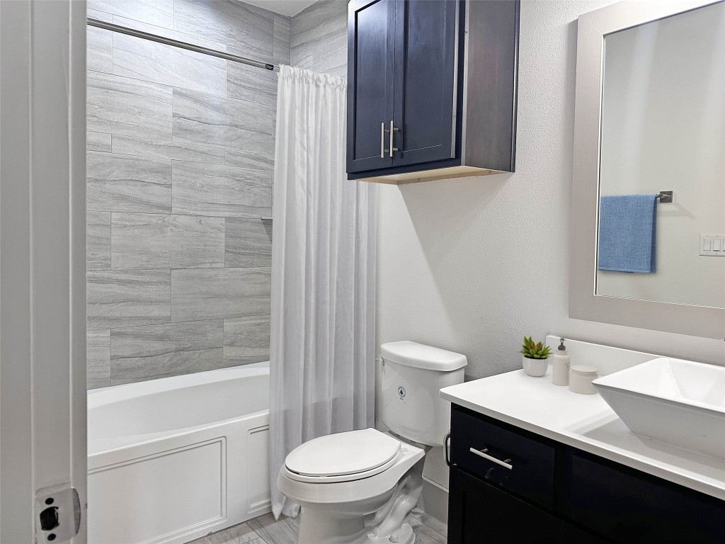 2727 Brazos Street, Unit 19 Houston, TX 77006 - Photo 3 of 19 a bathroom with a sink a toilet and shower