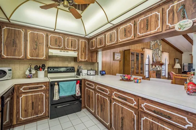 a kitchen with stainless steel appliances granite countertop a sink and cabinets