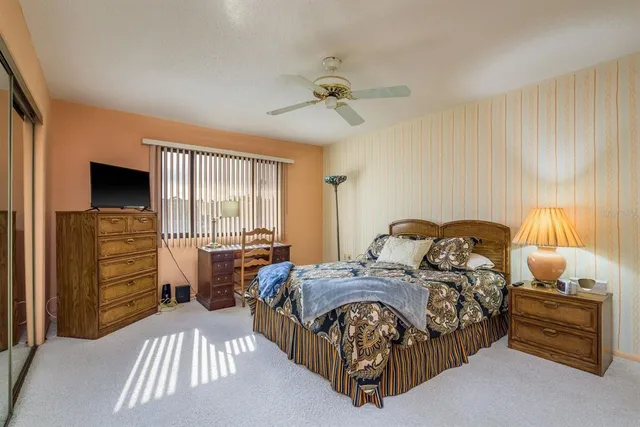 a bedroom with a bed and a television